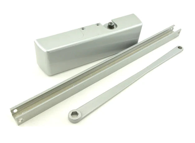 Silver door closer components:  housing, track, and arm.