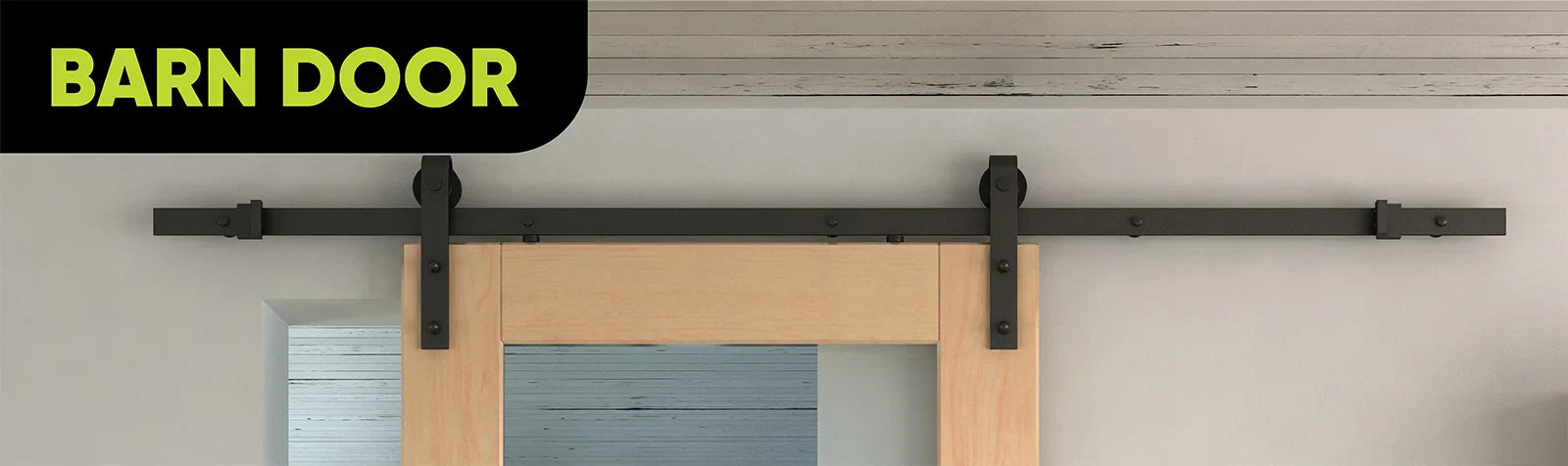 Black sliding barn door hardware on light wood door against a neutral wall.