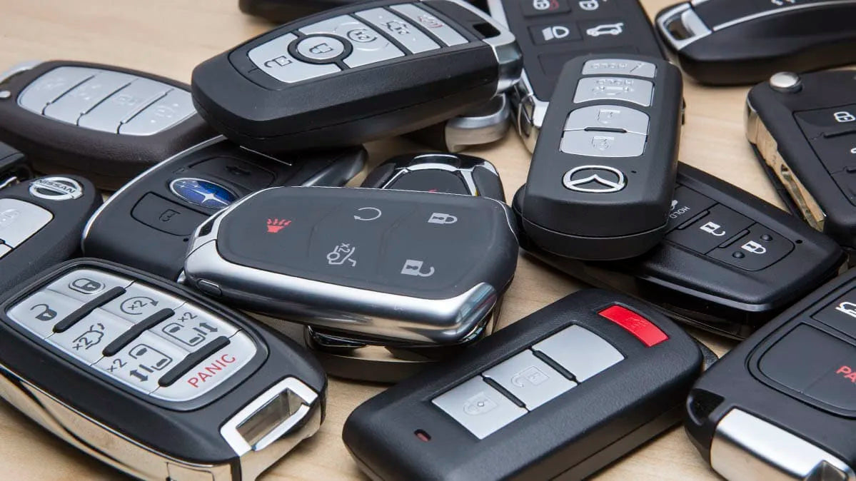 Variety of car key fobs on wood surface