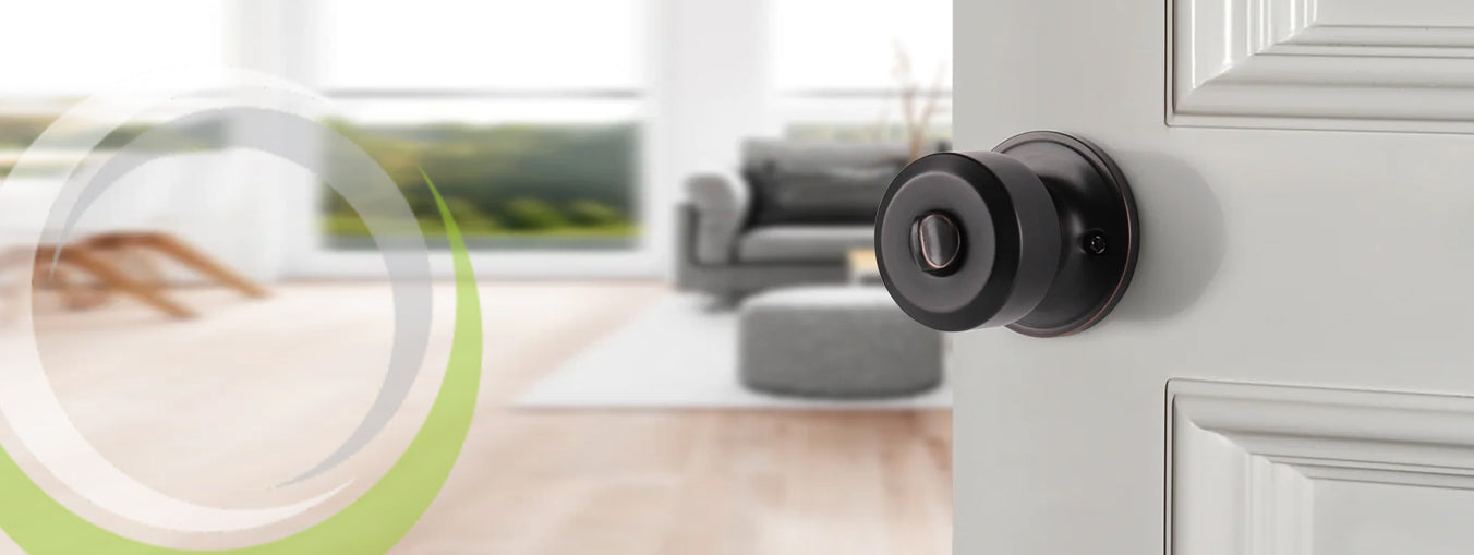 Black interior door knob on white door, modern living room background.